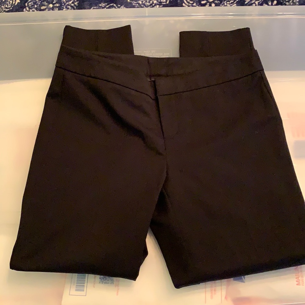 Slim black ankle crop stretch cotton pants with embroidered details at hem.
